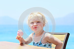 Little girl eating ice cream outdoors