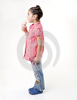 Little girl eating ice cream profile