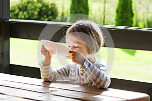 Little Girl Eating Outdoors