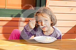 Little Girl Eating Outdoors