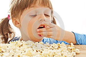 Little girl eating popcorn