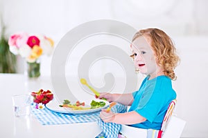 Little girl eating salad for lunch