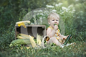 Little girl eating self grown cucumber