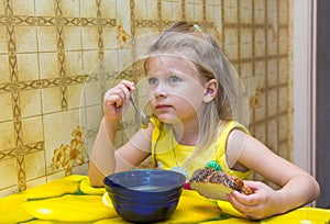 Little girl eating soup