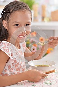 Little girl eating soup