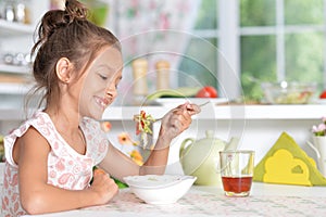 Little girl eating soup