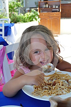 little girl eating spaghetti
