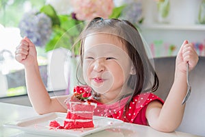Little girl eating strawberry cake