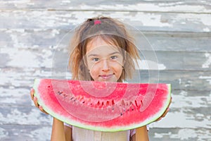 Little girl eating tasty watermelon