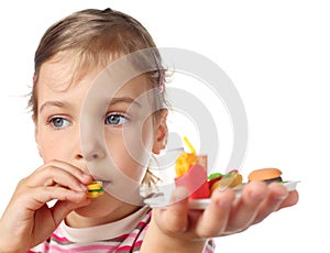 Little girl eating toy miniature burger