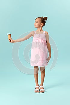 little girl eating vanilla ice cream in waffle cone