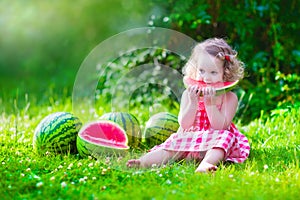 Little girl eating watermelon