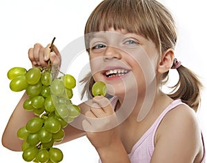 Little girl eating a wine grapes
