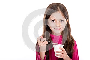 Little girl eating yoghurt