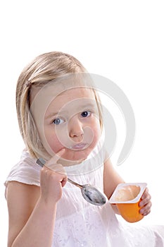 Little girl eating youghurt