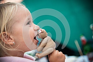 little girl eats cake