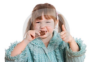The little girl eats chocolate photo