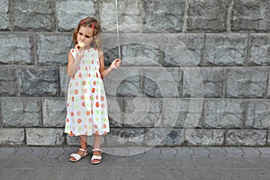 Little girl eats an ice-cream