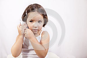 Little girl with electronic thermometer