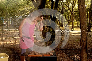 Little girl elementary age cooking the Ãâ¡evapi on barbecue gri photo