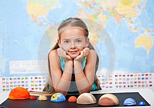 Little girl in elementary science class with her home project