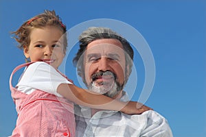 Little girl embracing grandfather