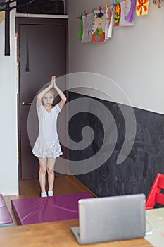 Little girl is engaged in ballet.