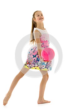 Little girl is engaged in fitness with a ball.