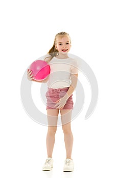 Little girl is engaged in fitness with a ball.