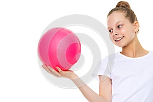 little girl is engaged in fitness with a ball.