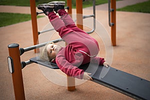 A little girl is engaged on an outdoor sports simulator