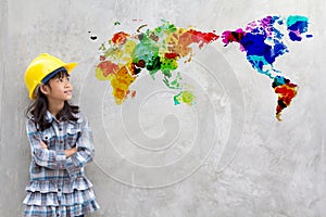 Little girl engineering with watercolor world map