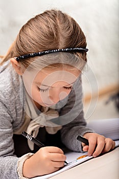 Little girl, engrossed in drawing, interprets stories