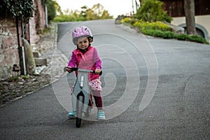 Little girl enjoying bike ride on warm summer day