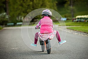 Little girl enjoying bike ride on warm summer day