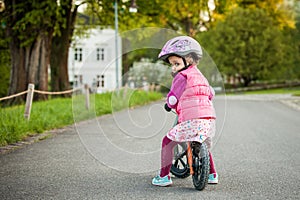 Little girl enjoying bike ride on warm summer day