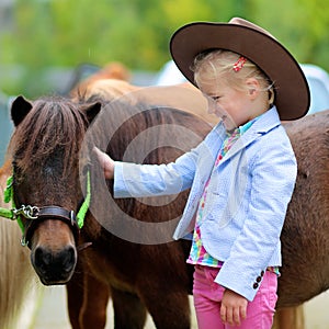 Little girl enjoying her pony