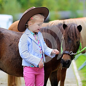 Little girl enjoying her pony