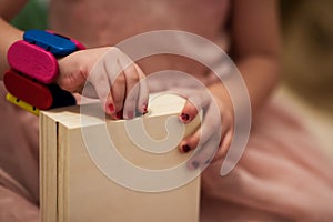 Little girl enjoying while playing with mother`s jewelry