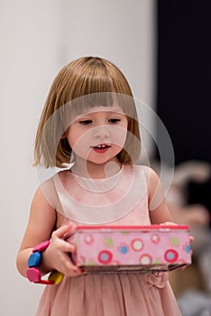 Little girl enjoying while playing with mother`s jewelry