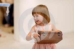 Little girl enjoying while playing with mother`s jewelry