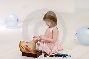 Little girl enjoying while playing with mother`s jewelry