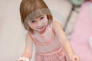 Little girl enjoying while playing with mother`s jewelry