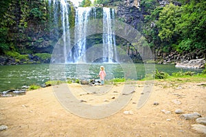 Little girl enjoying Spectacular view of Whangarei Falls, New Zealand