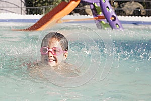 Little girl enjoying the summer at swiming pool