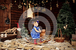 A little girl enjoys riding a rocking horse that was given to her for Christmas