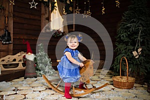 A little girl enjoys riding a rocking horse that was given to her for Christmas