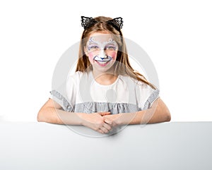 Little girl with face art holding a sheet for your adverisement or text isolated