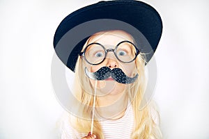 Little girl with fake moustache on stick
