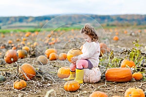 Little girl farming on pumpkin patch